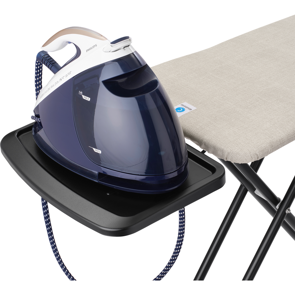 Steam iron on ironing board rest, close-up.