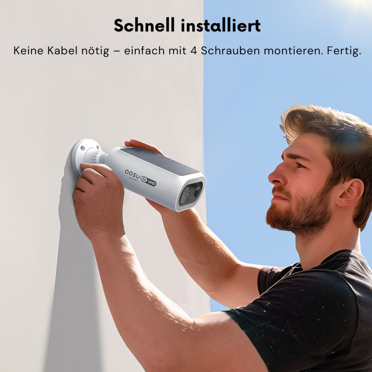 Mann montiert weiße Überwachungskamera mit Solarpanel an Wand.