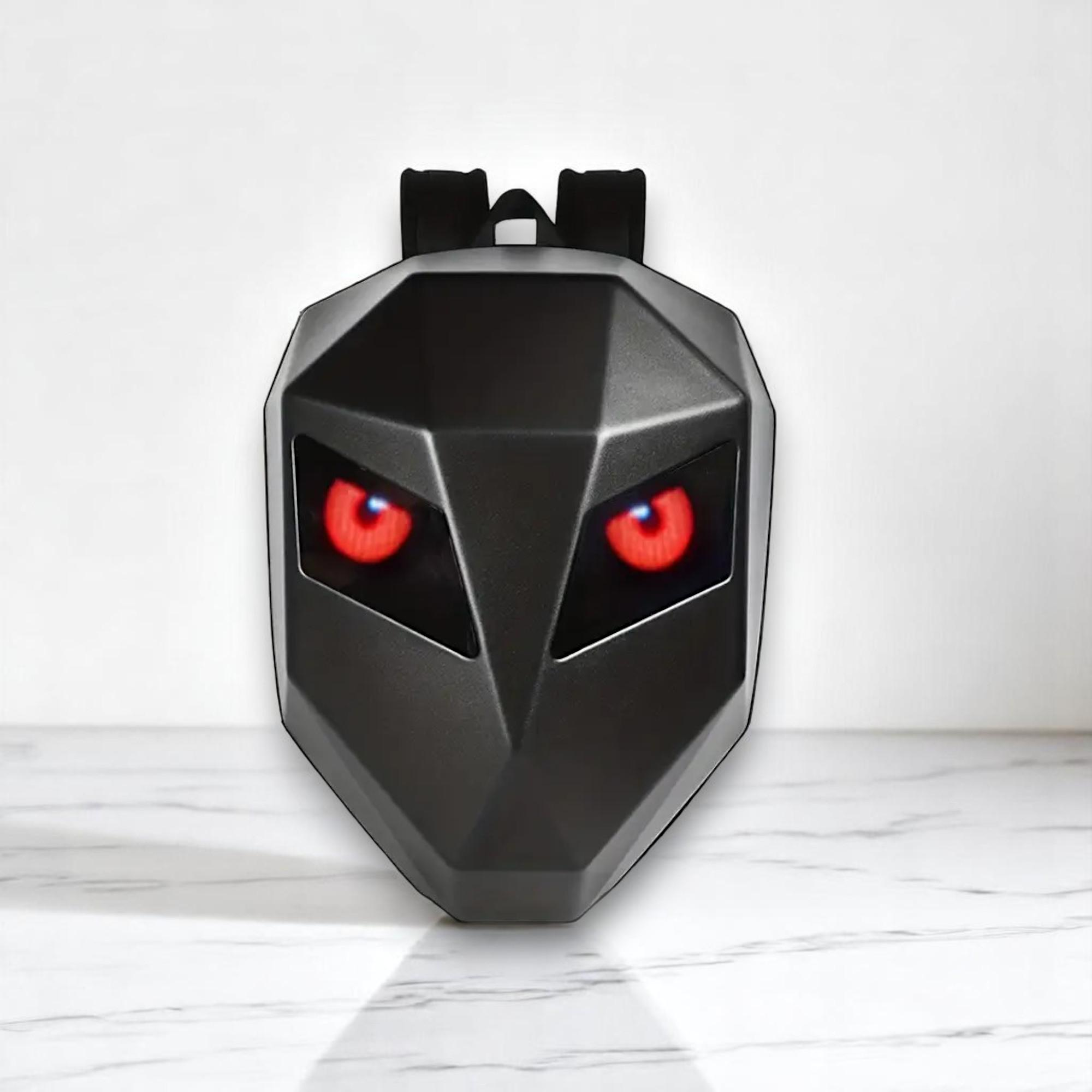 Mochila negra con ojos rojos brillantes, diseño de máscara.