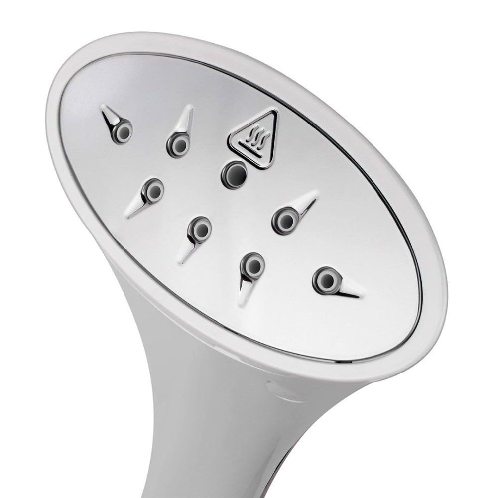 Zbliżenie metalowej głowicy żelazka parowego z otworami parowymi i symbolem ostrzegawczym.