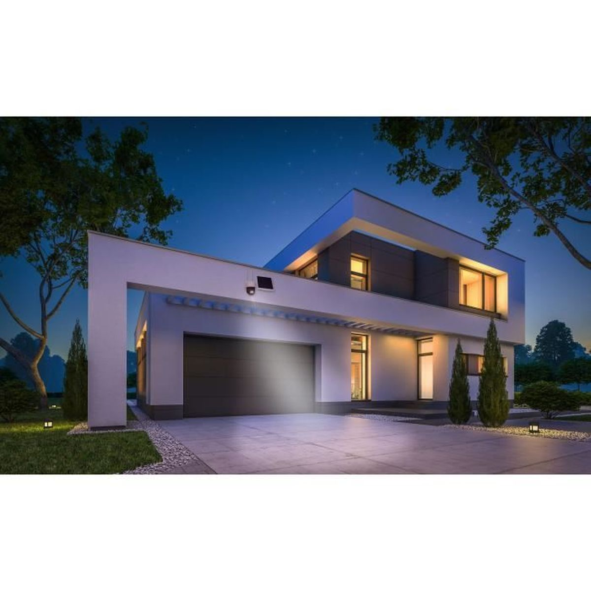 Modern huis 's nachts met garage verlicht door beveiligingslamp.