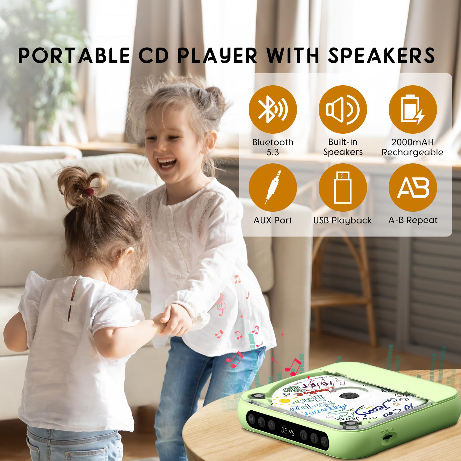 Zwei kleine Mädchen tanzen vor einem tragbaren CD-Player mit Lautsprechern.