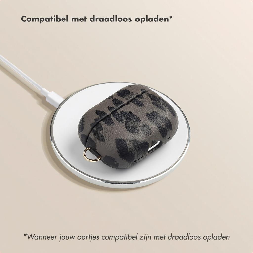 A leopard print case for wireless charging on a white charging pad.