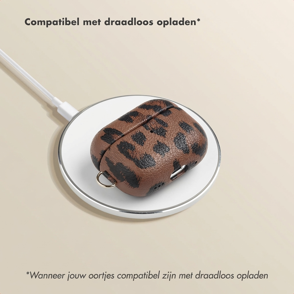 Brown leopard print case on a white wireless charging pad.