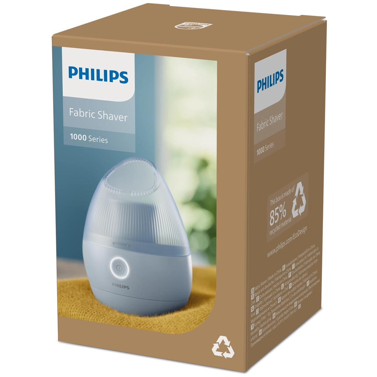 Philips Fabric Shaver 1000 Serisi mavi renkte sarı bez üzerinde, kutuda.