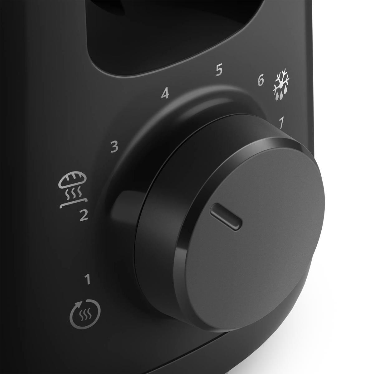 Primo piano di una manopola nera con segni e icone per toast e cibi surgelati.
