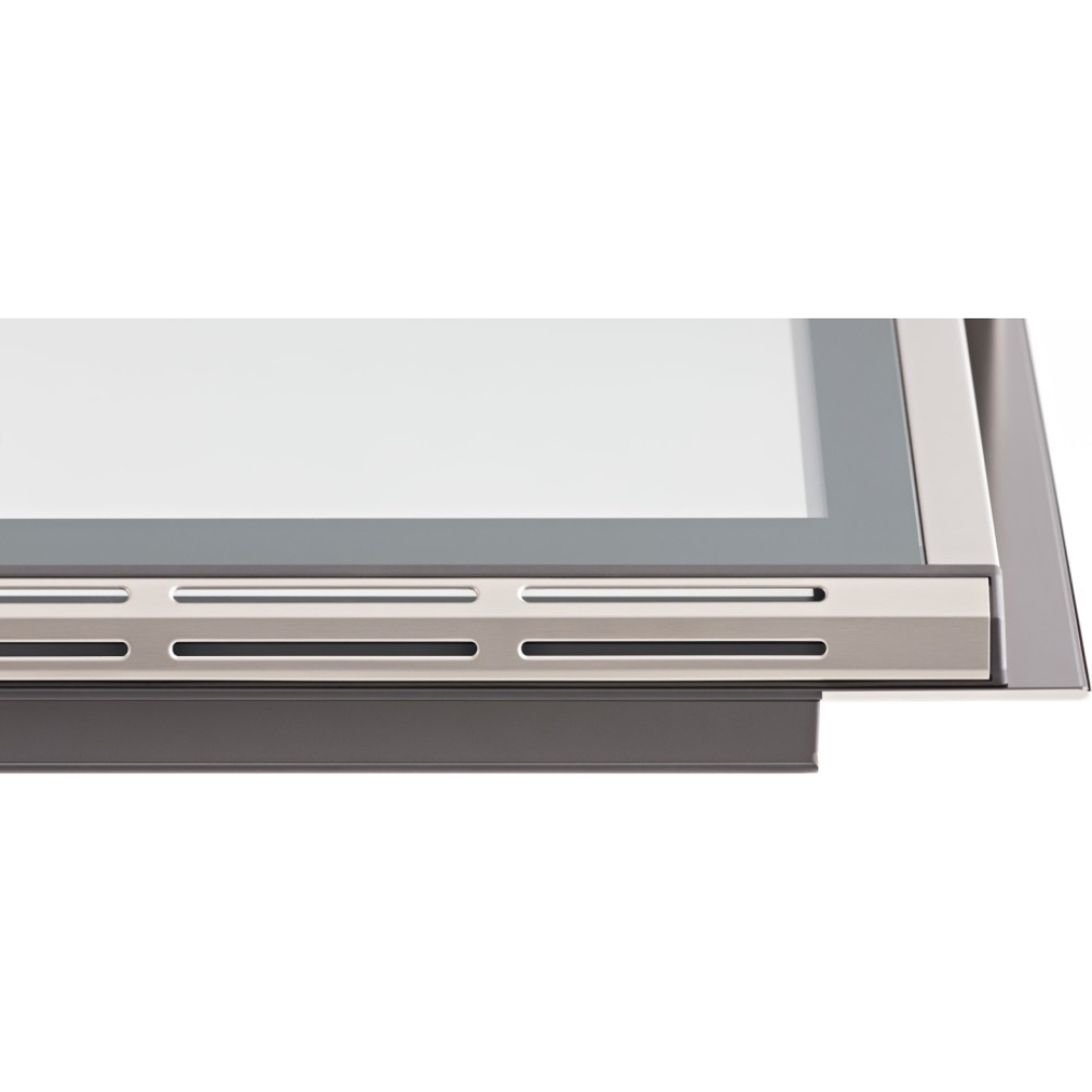 Dettaglio di una finestra moderna con cornice argentata e fessure di ventilazione.