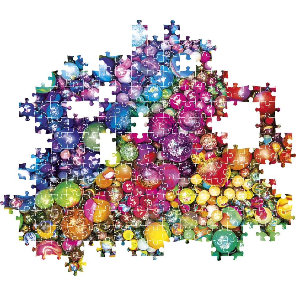 An incomplete puzzle featuring colorful glass marbles of various sizes and colors.