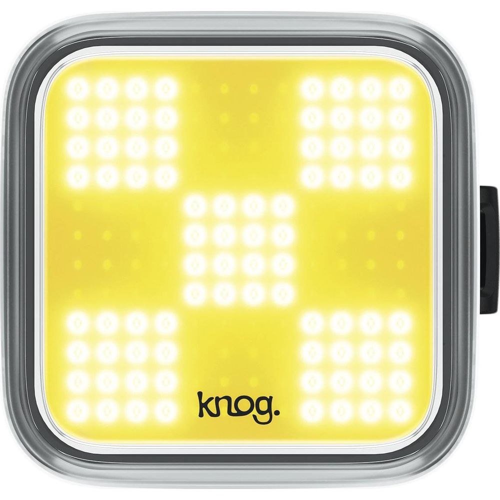 Ein leuchtend gelbes Fahrradlicht mit einem Muster aus kleinen Lichtern und dem Knog-Logo.