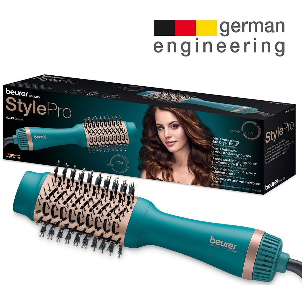 Un cepillo secador de pelo 2 en 1 turquesa y su embalaje. Logo "german engineering".