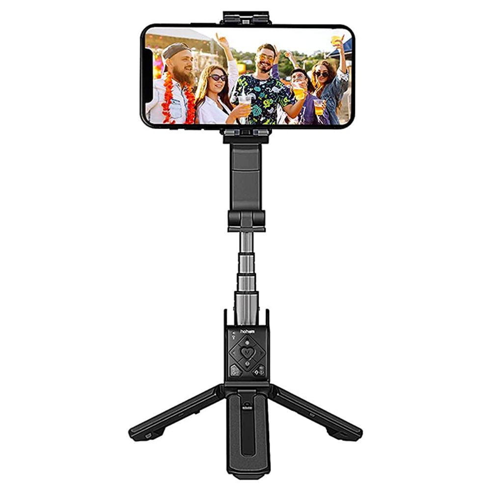 Czarny kijek do selfie z uchwytem na telefon i nogami statywu, pokazujący grupę ludzi.