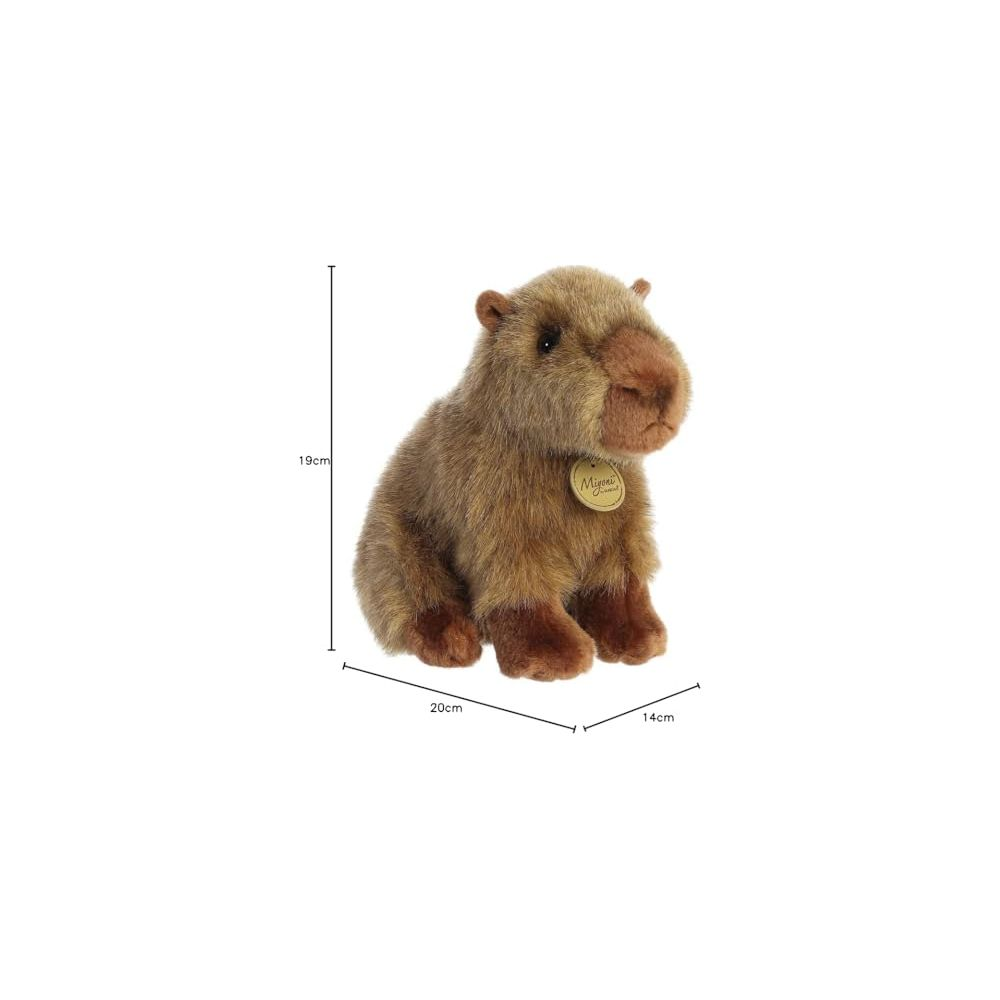 Un capibara giocattolo di peluche marrone siede rivolto a destra, dimensioni 19cm A, 20cm L, 14cm P.