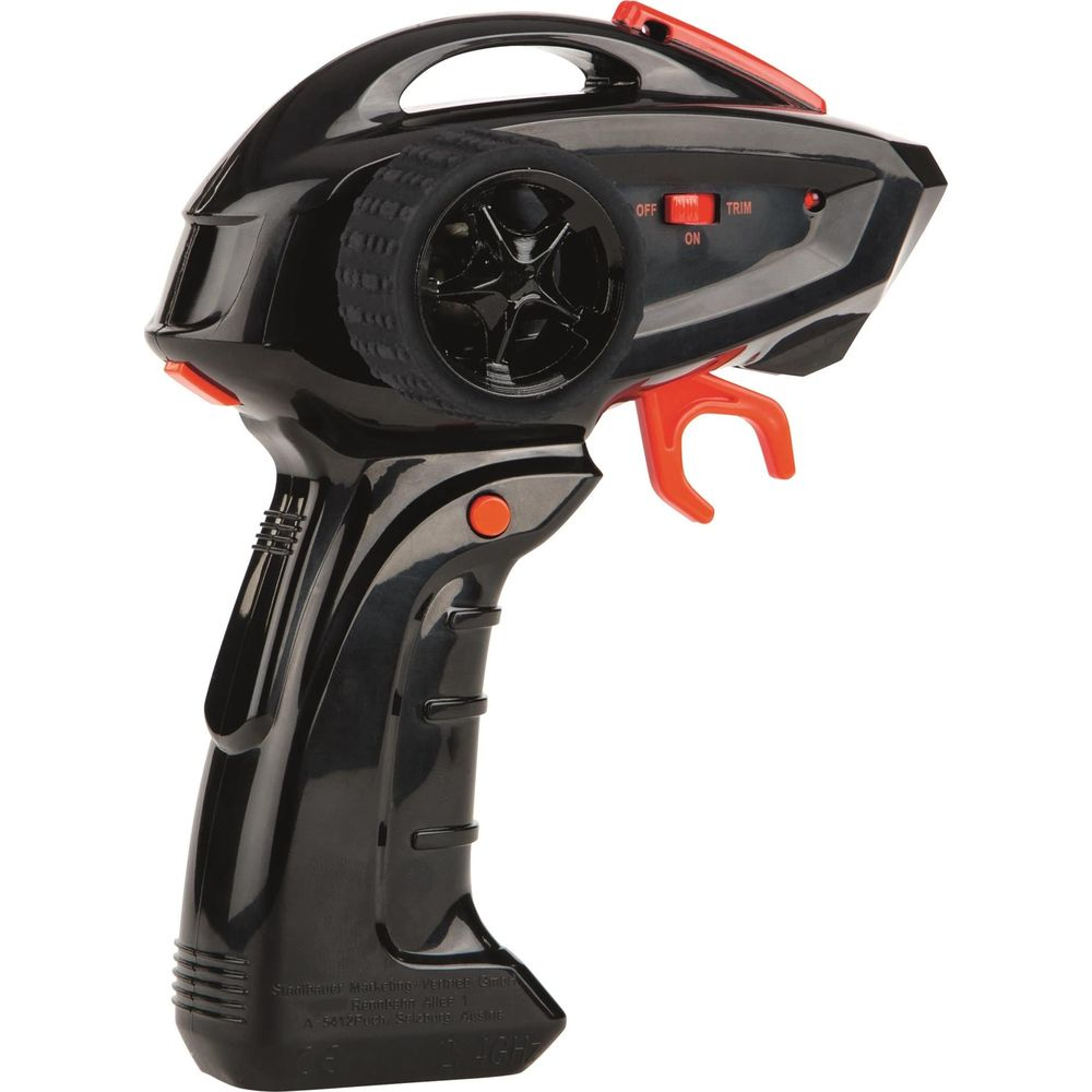 Un control remoto de coche RC negro con detalles rojos y un volante.