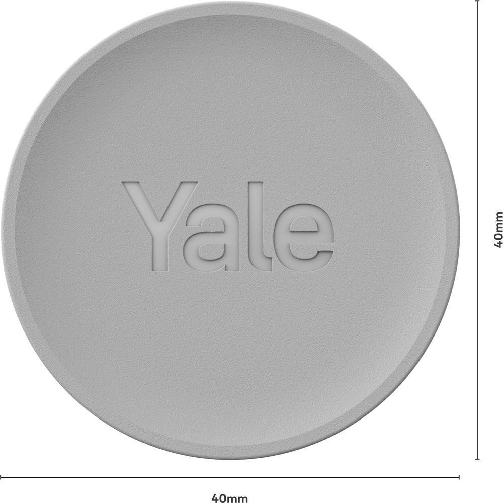 Oggetto rotondo grigio con logo Yale inciso e marcature dimensionali.