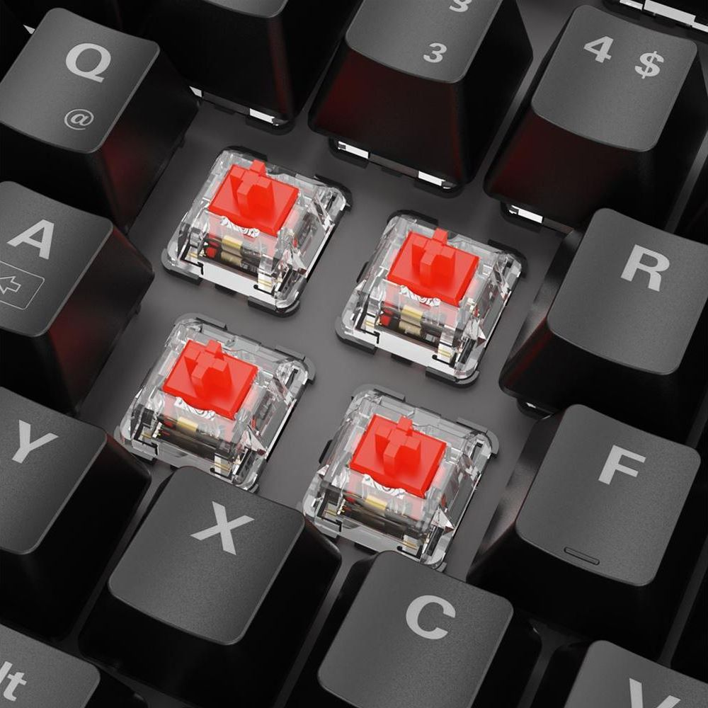 Four red mechanical keyboard switches are shown on a keyboard with black keys.