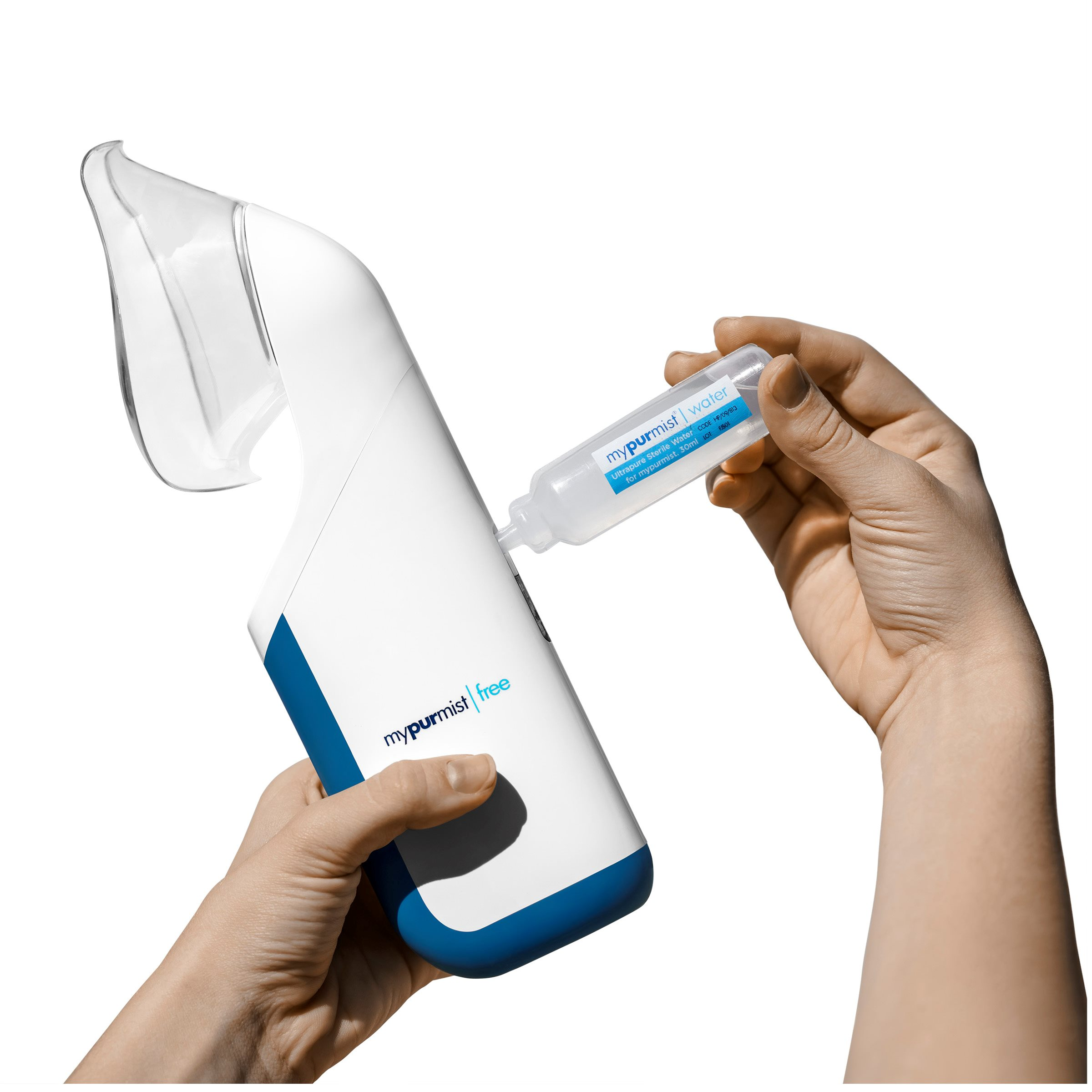 A hand fills a white nebulizer with a blue stripe using a small water bottle.