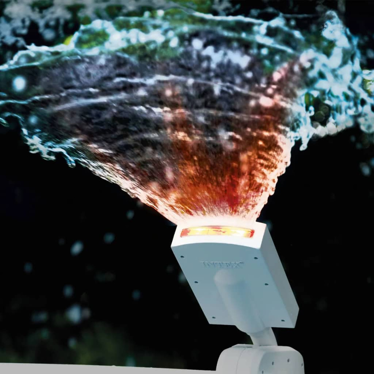 Biały reflektor basenowy oświetla element wodny kolorowymi światłami i pluskami wody.