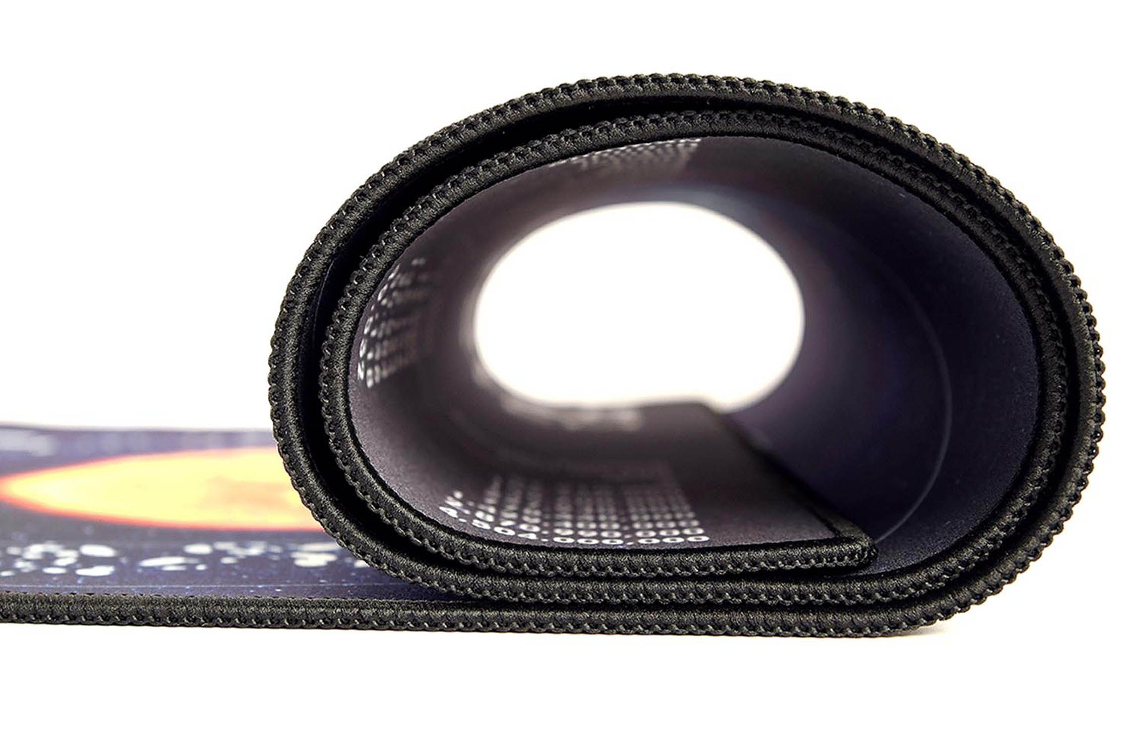 Tapis de souris noir enroulé avec un imprimé spatial sur le bord gauche.