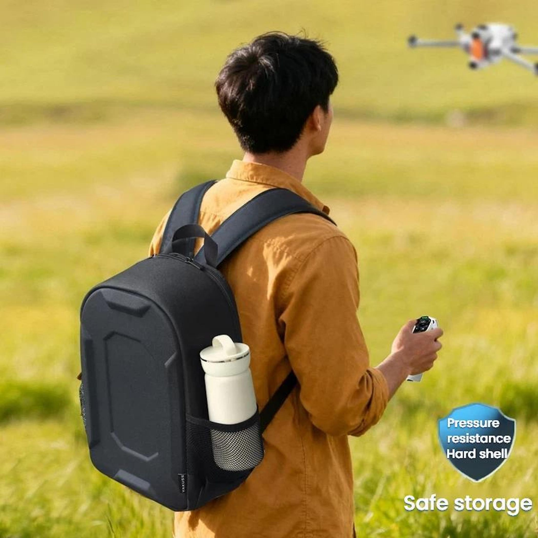Mann mit Rucksack, der eine Drohne in der Luft steuert.