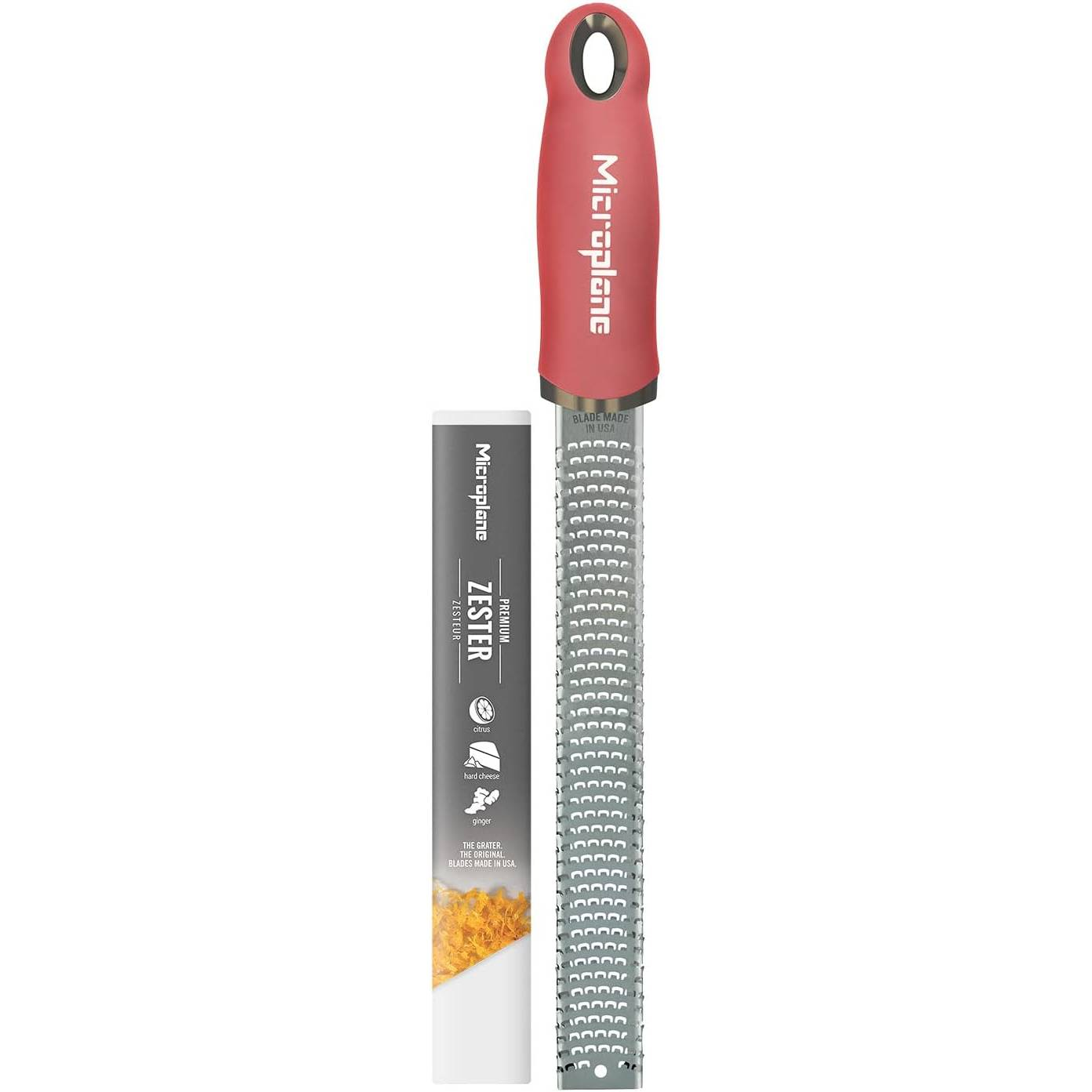 Metal bıçaklı kırmızı bir Microplane rendesi ve rendelenmiş peynir.