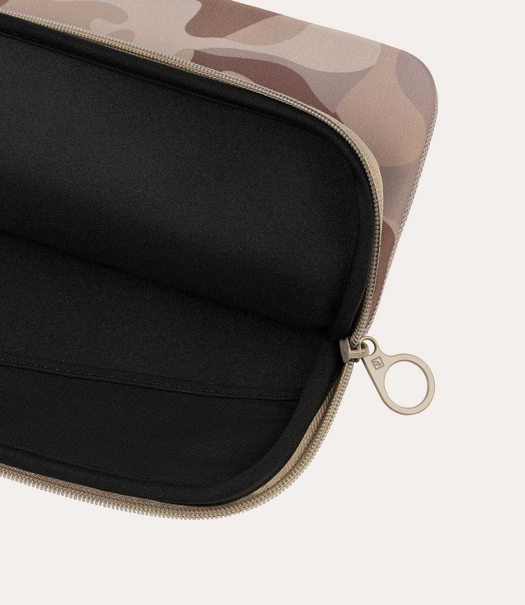 Bolso abierto de camuflaje marrón con interior negro y tirador de cremallera.