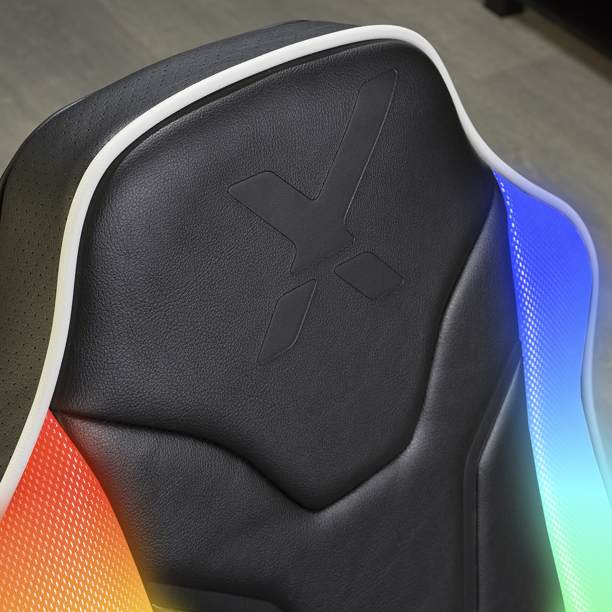 Silla gamer negra con ribete blanco e iluminación LED arcoíris.