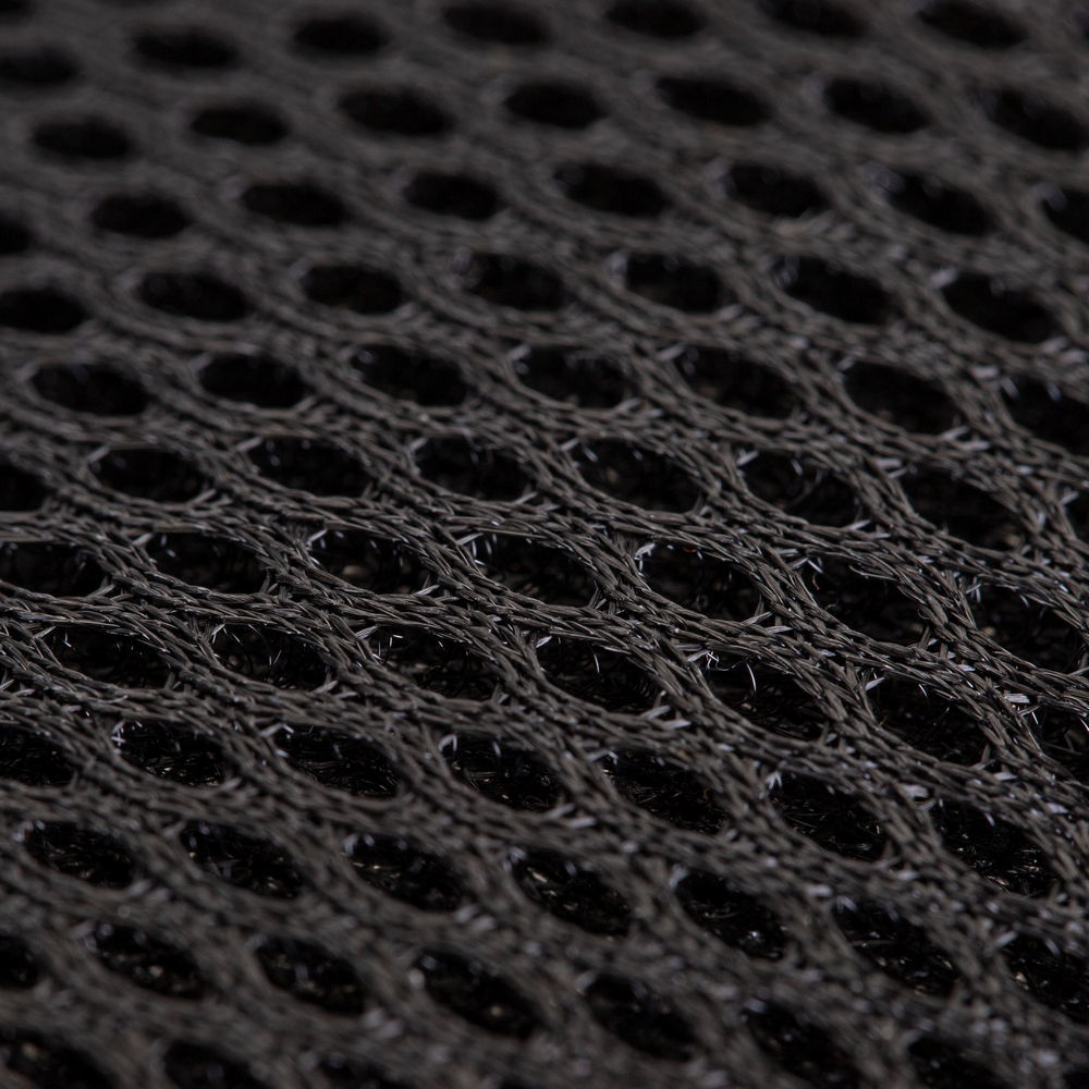 Primo piano di tessuto a rete intrecciato nero con aperture ovali, creando una texture a rete.