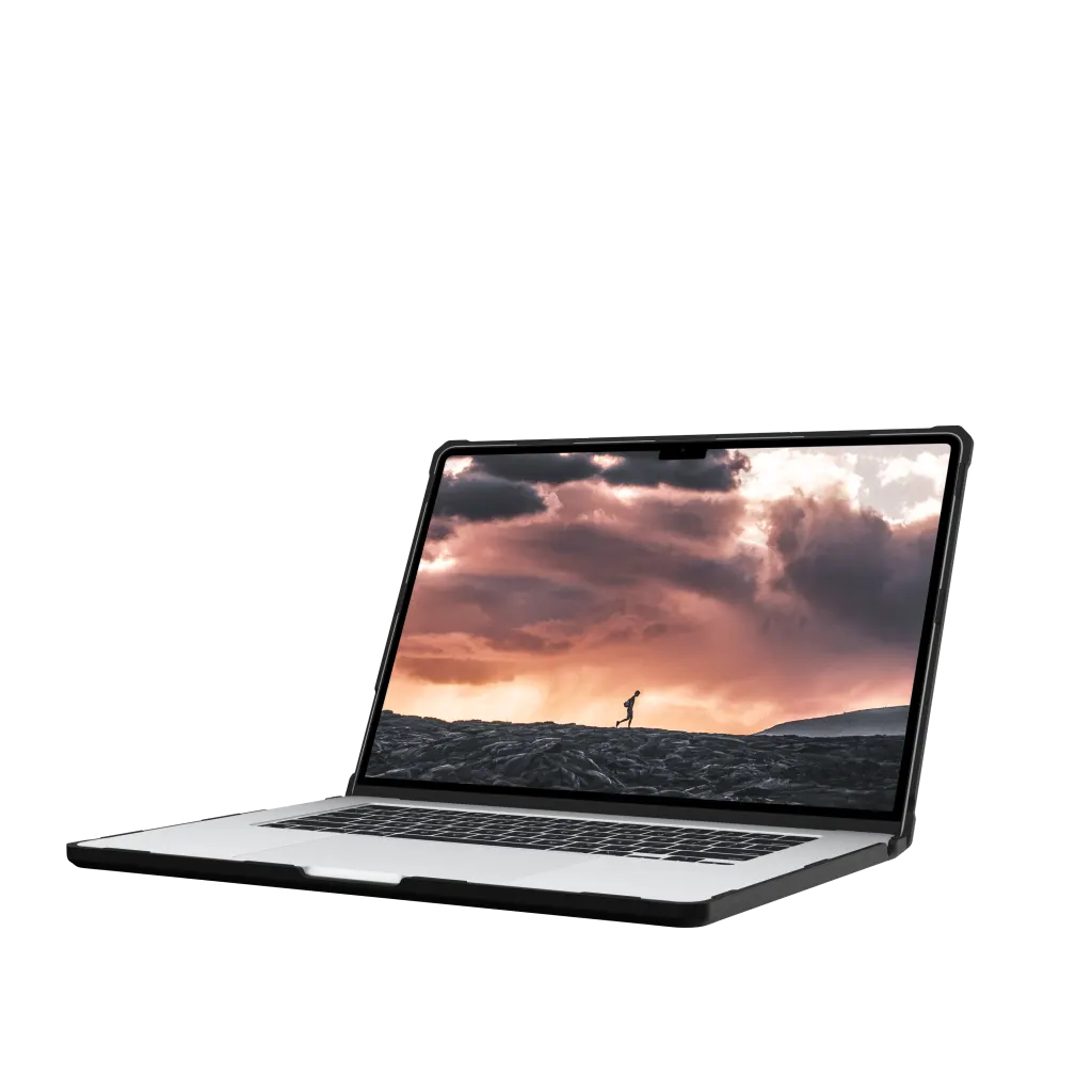 Laptop wyświetla osobę biegnącą o zachodzie słońca po skalistym terenie.