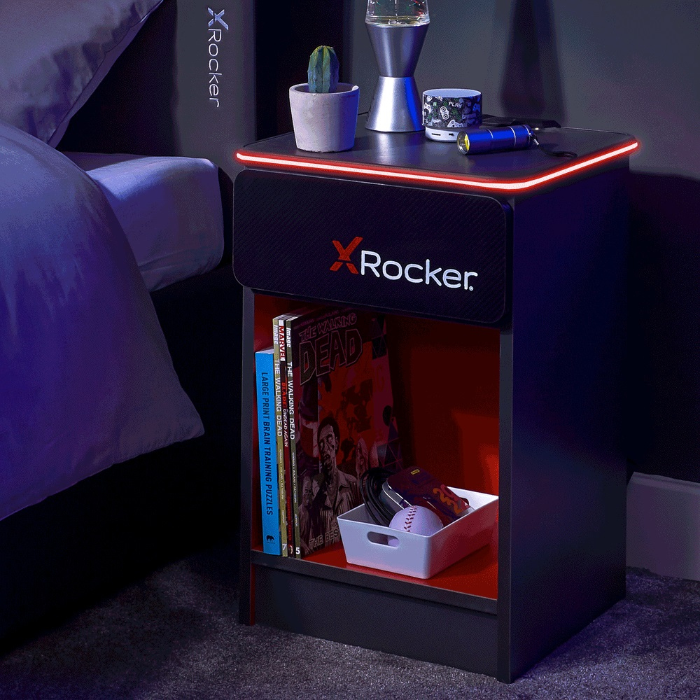 Ein Nachttisch mit Büchern, einer Lampe und einer Pflanze.