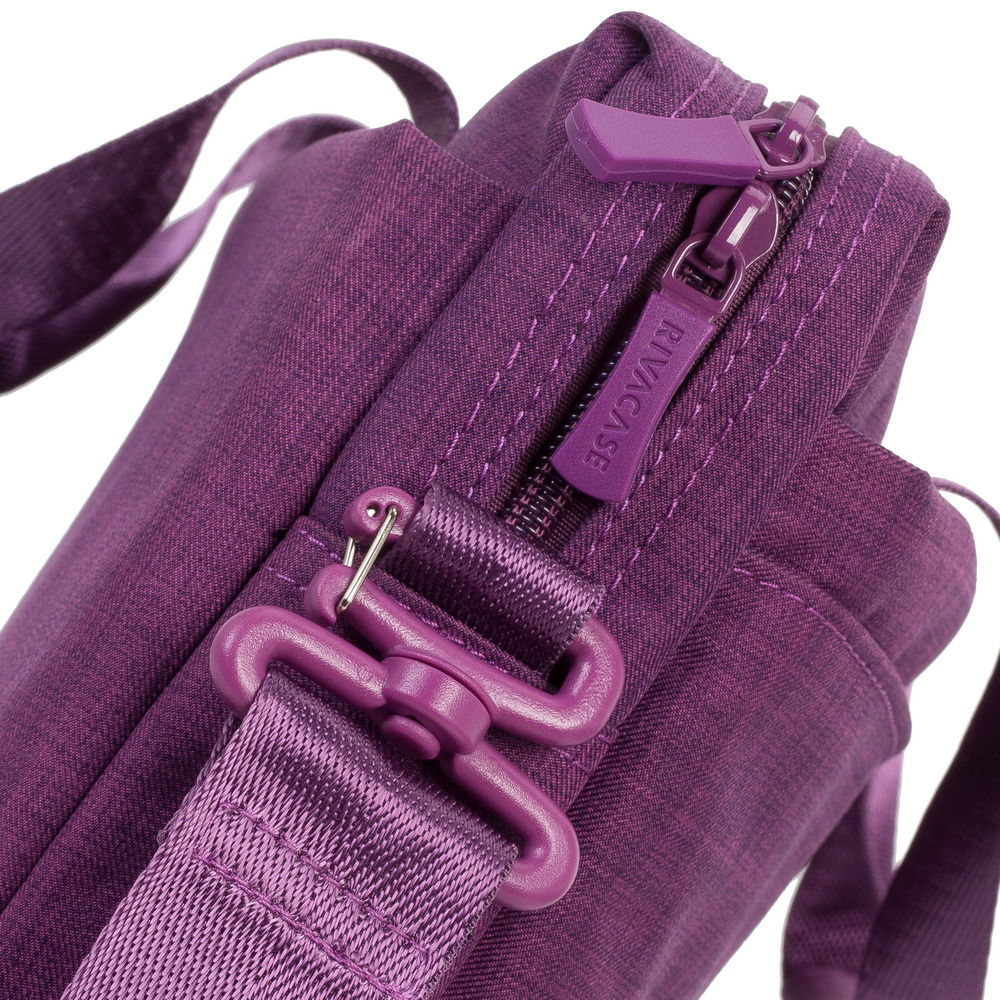 Nahaufnahme einer violetten Tasche mit Reißverschluss und Tragegurt.