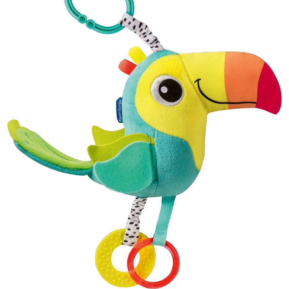 Un tucano di peluche colorato appeso a un anello sopra due anelli massaggiagengive.