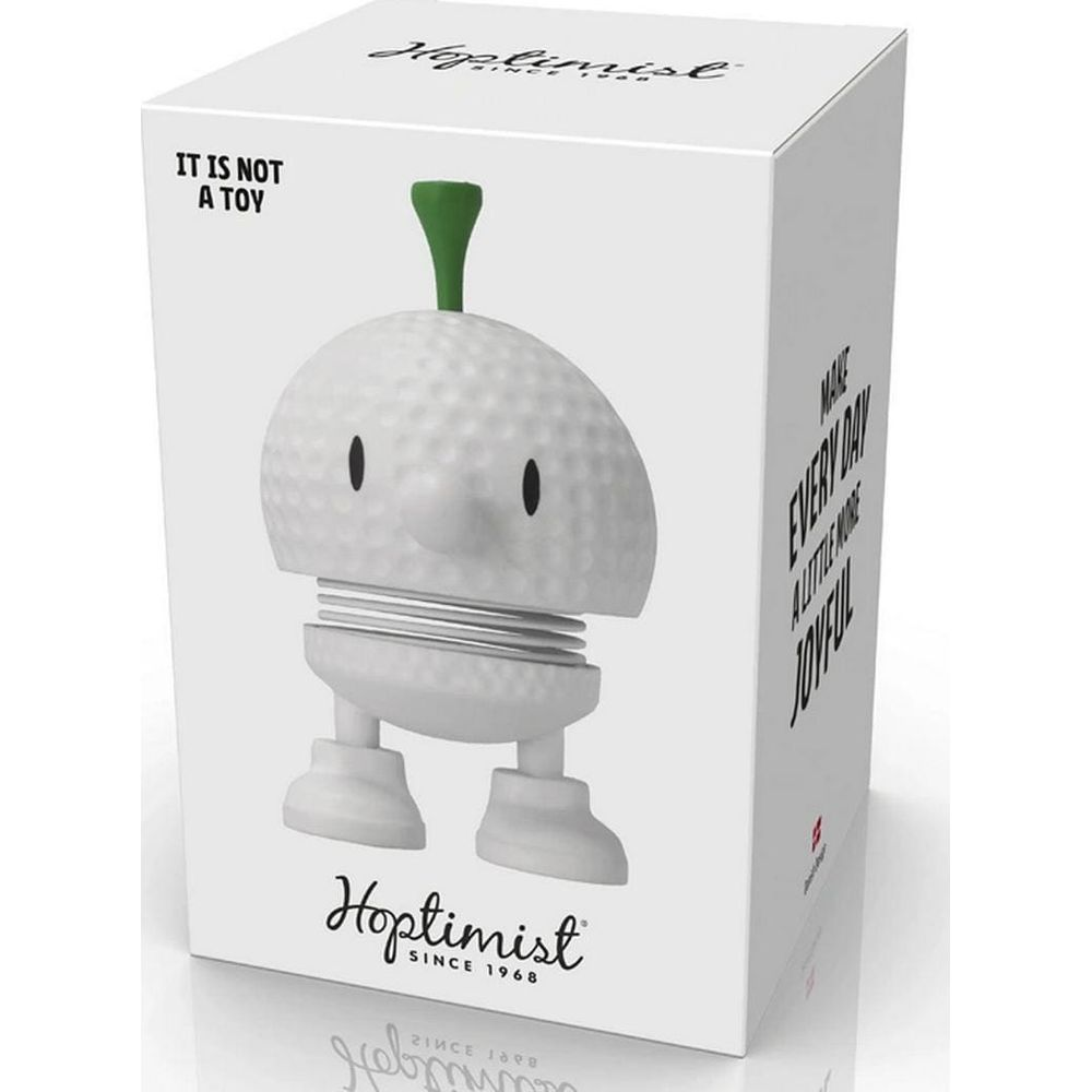 Figura Hoptimist bianca con stelo verde su una scatola. Testo: 'IT IS NOT A TOY'.