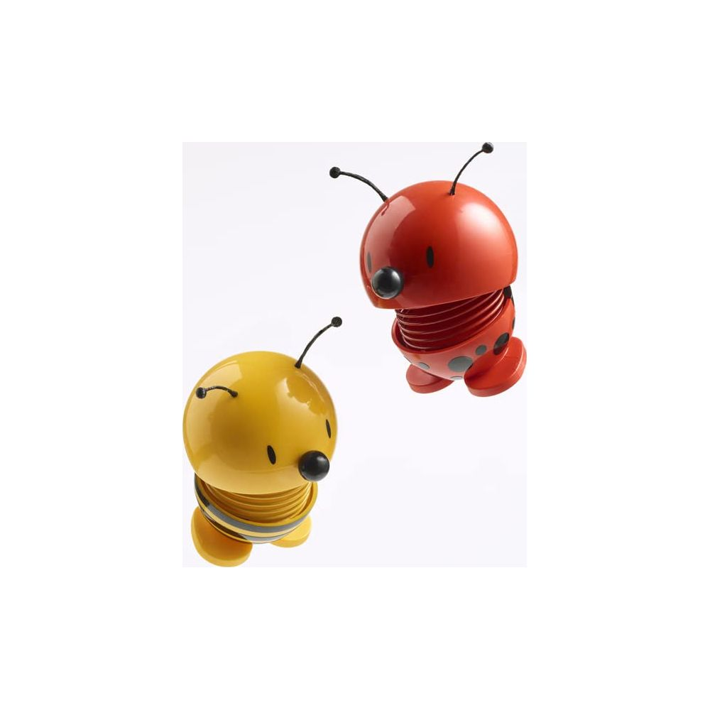Un giocattolo ape giallo e un giocattolo coccinella rosso con molle.
