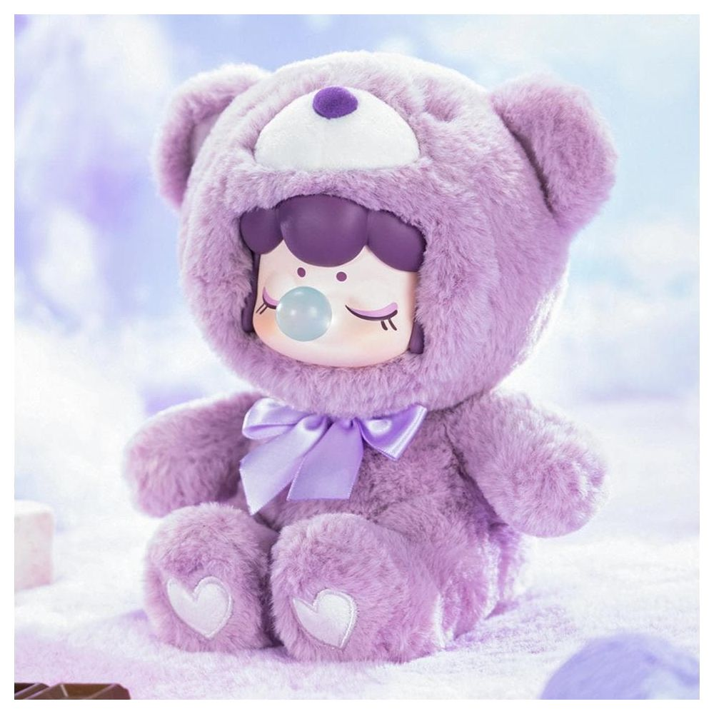 Une figurine d'ours en peluche violette avec un visage mignon et une bulle.