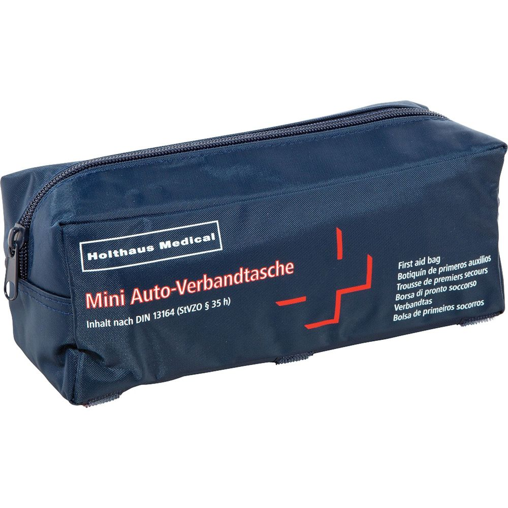 Dunkelblaue Verbandtasche mit roten Kreuz-Symbol und Text in mehreren Sprachen.