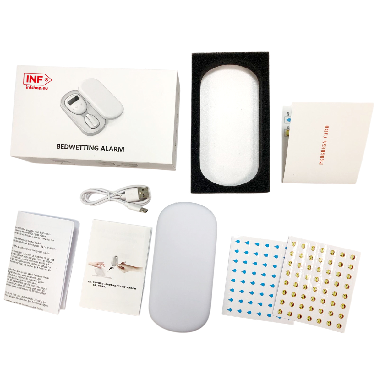 Ein Bettnässer-Alarm-Kit mit Handbuch, USB-Kabel, Aufklebern und einer Fortschrittskarte.