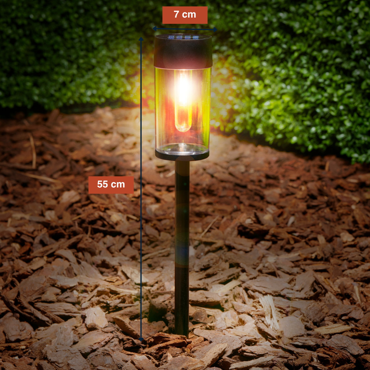 Garden lamp with glass cylinder, 55cm tall, 7cm wide, glowing yellow and red.