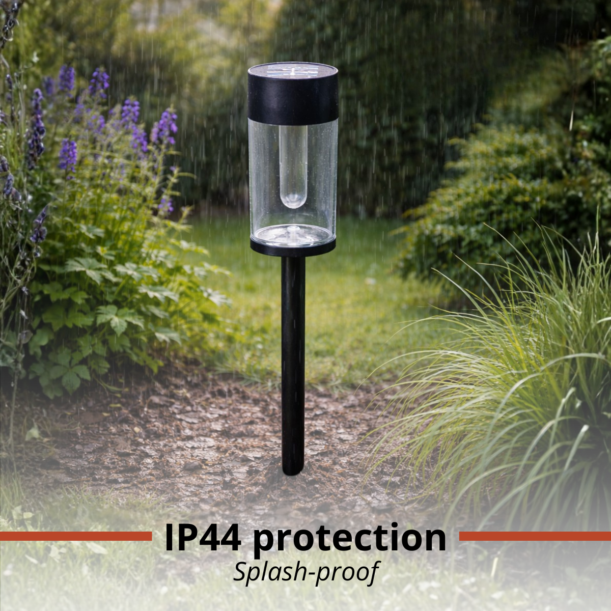 Garden light in rain with clear cylinder and black pole.