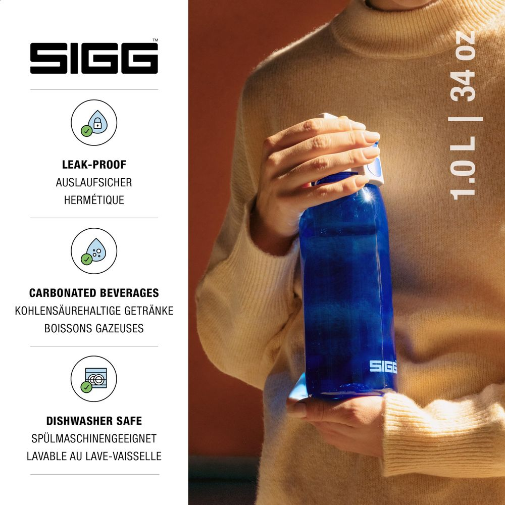 Eine Person hält eine blaue SIGG-Flasche, 1,0L/34oz. Links sind Produktmerkmale aufgeführt.