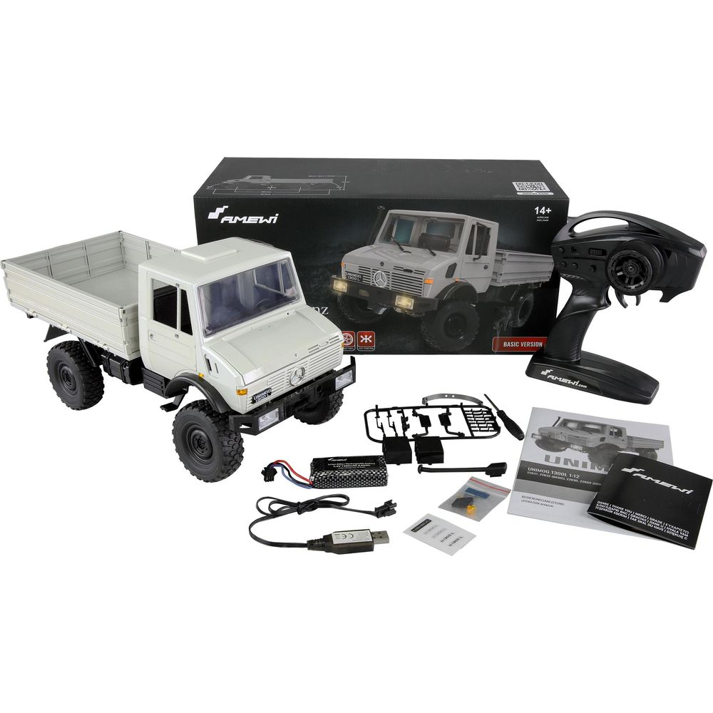 Camión Unimog RC blanco con control remoto, baterías y manual.