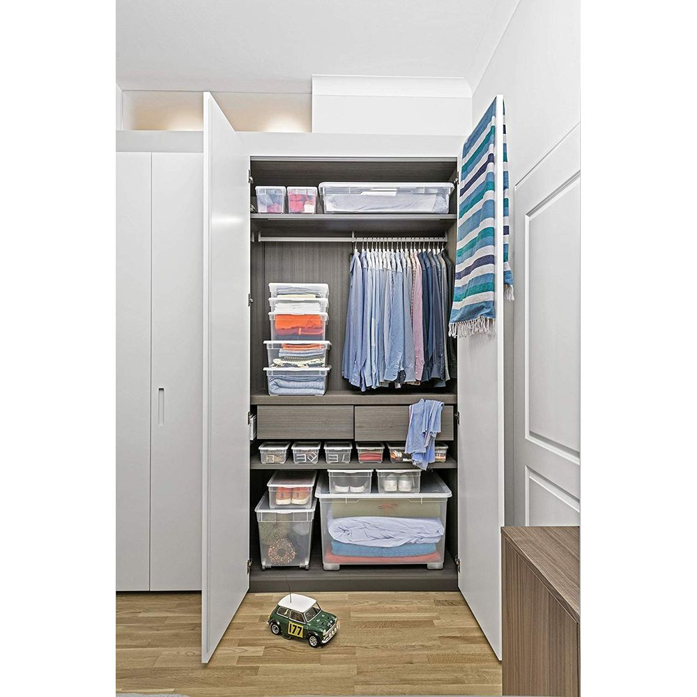 Offener Kleiderschrank mit Kleidung, Aufbewahrungsboxen und einer Spielzeugauto.