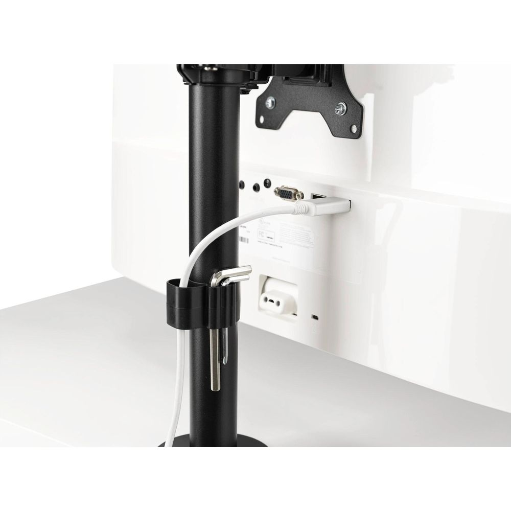 Black monitor stand holding cables, with Allen keys attached to the stand.