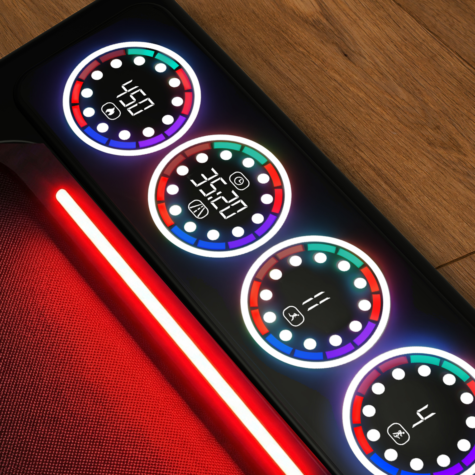 Bieżnia z czterema okrągłymi wyświetlaczami pokazującymi cyfry i ikony. Czerwona tkanina na pierwszym planie.