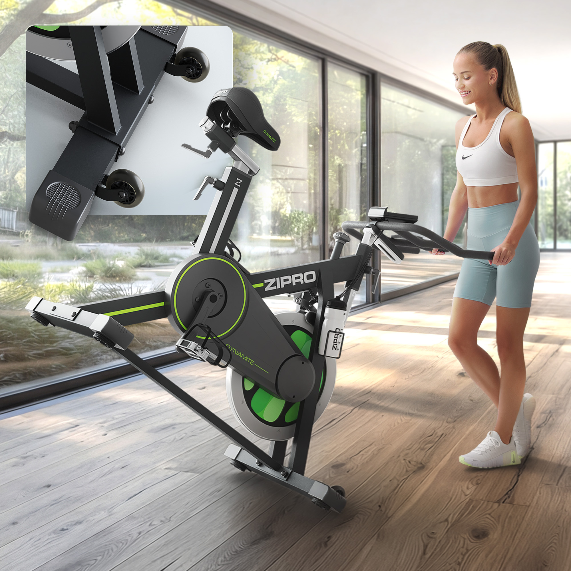 Eine Frau in Sportkleidung steht neben einem schwarzen Trainingsrad mit grünen Akzenten.