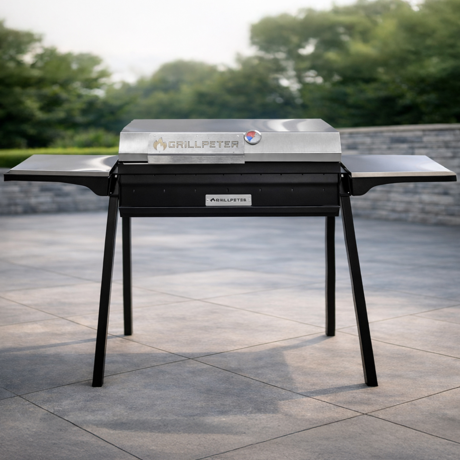 Ein silberner Grill mit schwarzem Gestell steht auf einer gefliesten Terrasse.