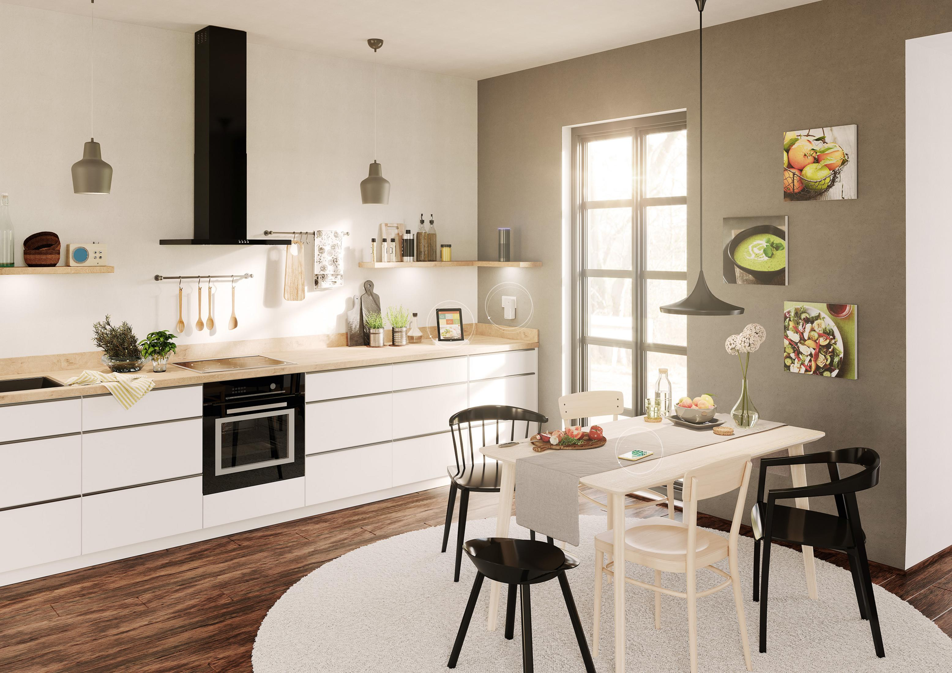 Cuisine moderne avec coin repas, armoires blanches, hotte noire et parquet.