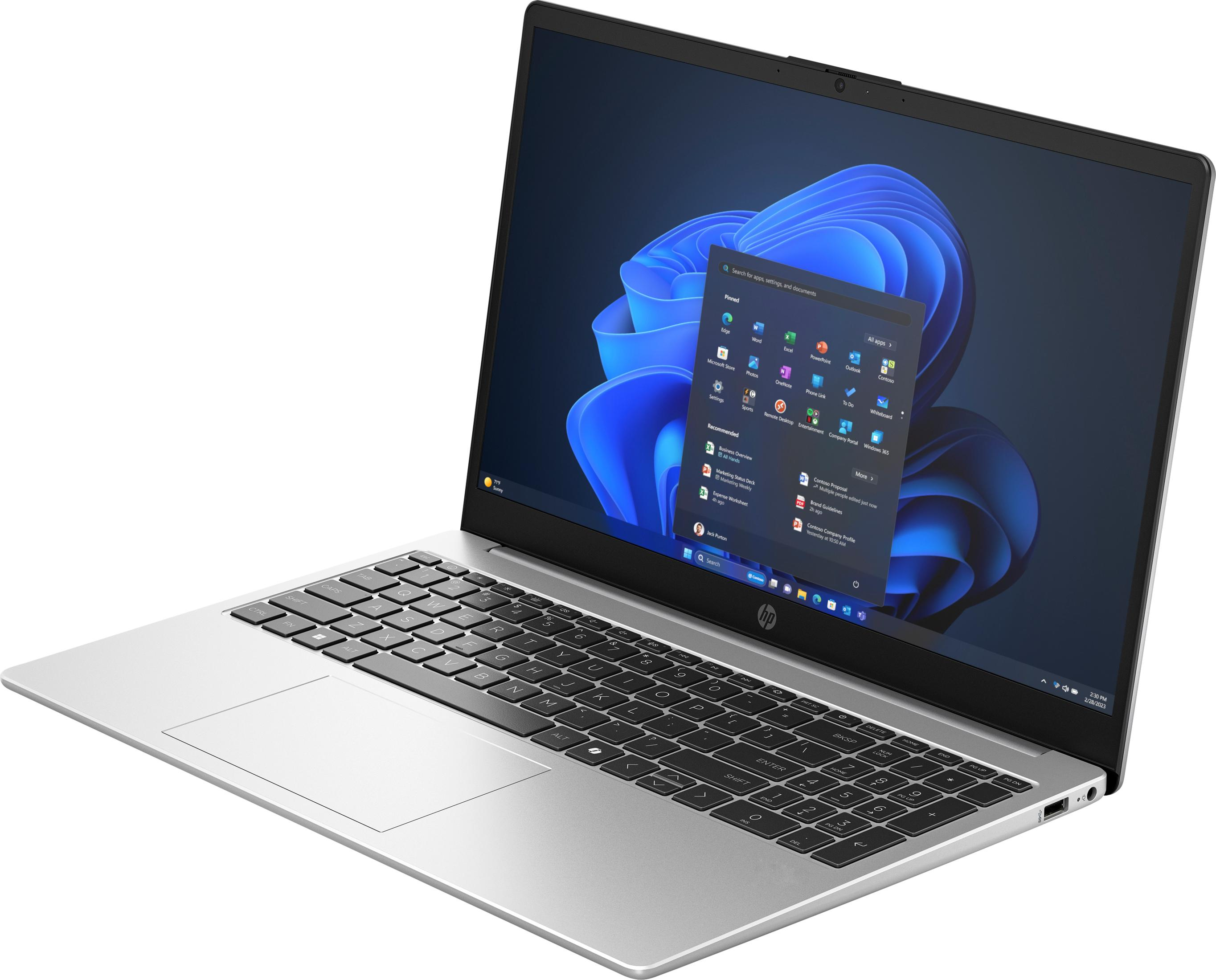 Srebrny laptop z otwartym, ciemnym ekranem, wyświetlającym menu startowe systemu Windows 11.