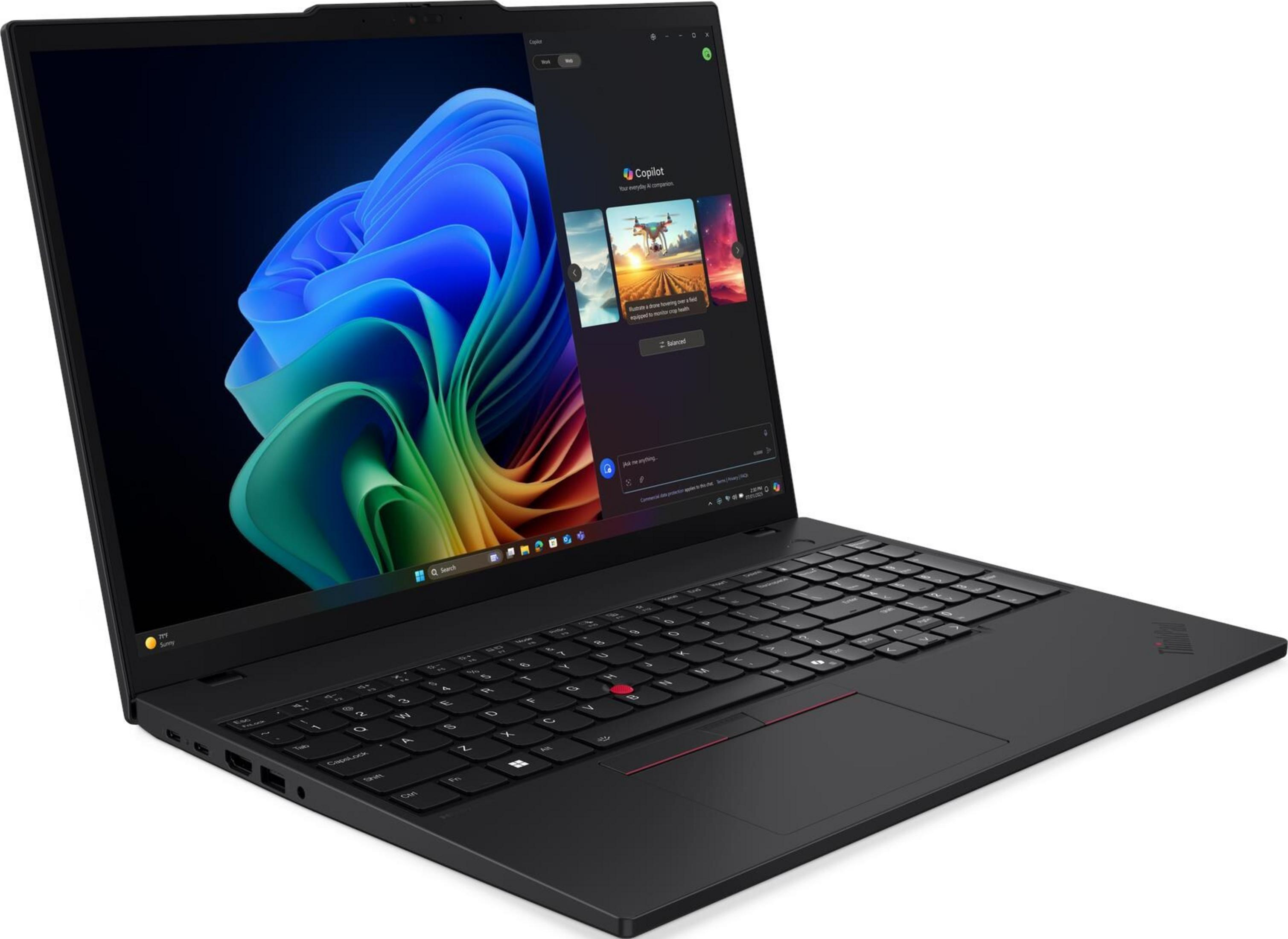 Czarny laptop z podświetlaną klawiaturą i kolorową tapetą na ekranie.