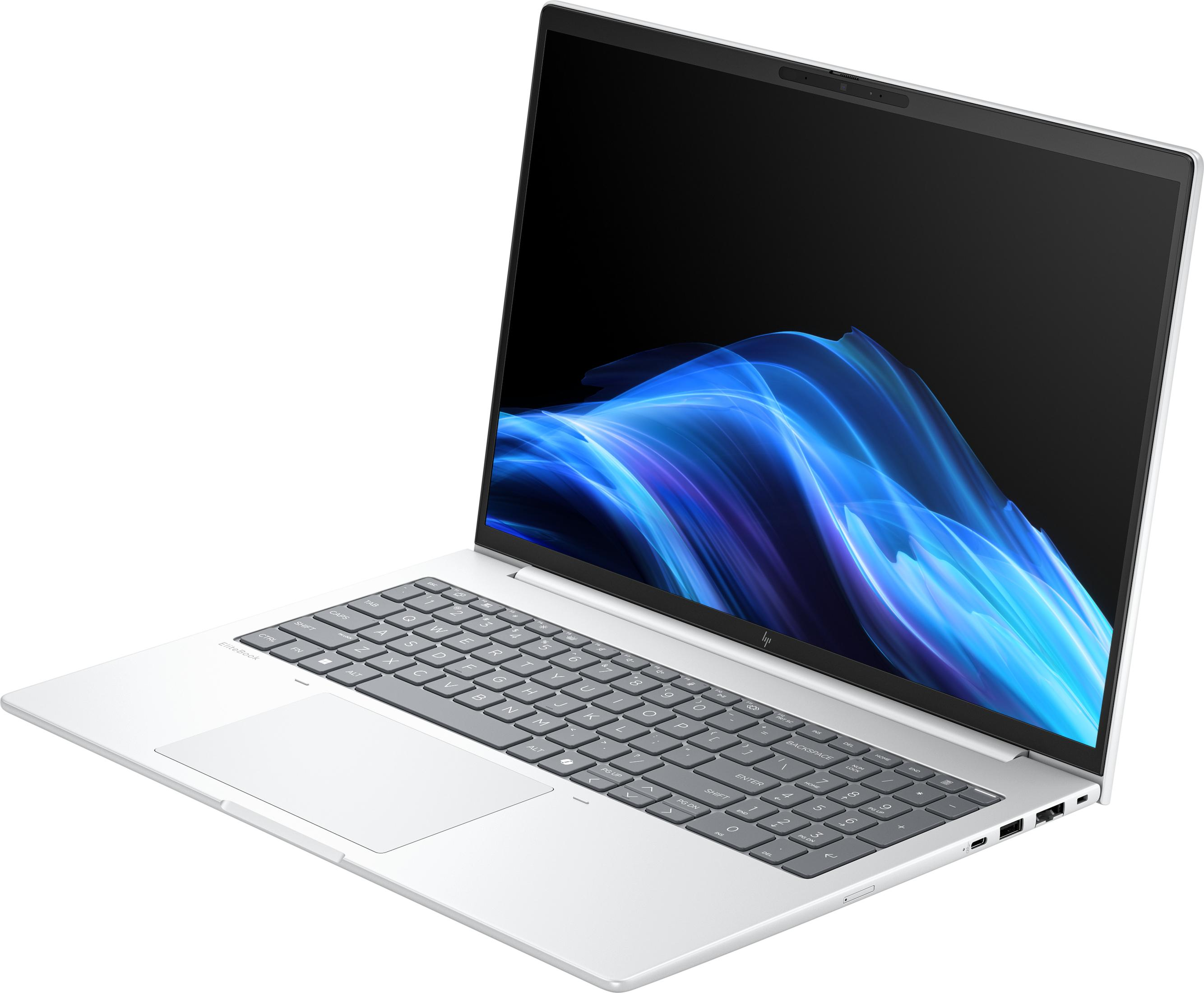 Ein silberner Laptop mit einem blauen, wellenförmigen Hintergrundbild auf dem Bildschirm.