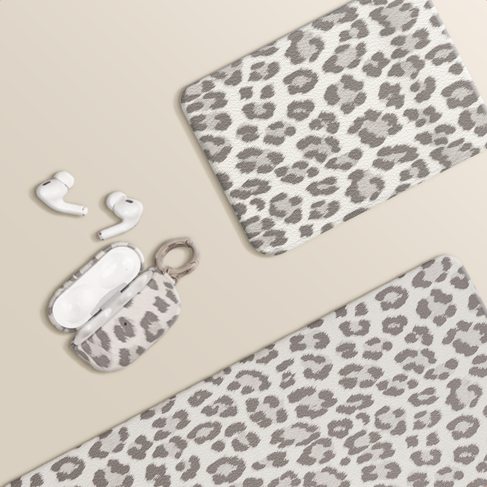 White earbuds and an open leopard print case on a beige background.
